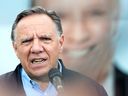 Coalition Avenir Québec Leader François Legault speaks to reporters during an election campaign stop in L'Assomption, Que., Sunday, September 25, 2022. Quebecers will go to the polls on Oct. 3.