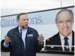 Coalition Avenir Québec Leader François Legault speaks to reporters during an election campaign stop in L'Assomption, Que., Sunday, September 25, 2022. Quebecers will go to the polls on October 3rd.