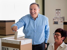 Coalition Avenir Québec Leader François Legault casts his ballot ahead of the election during a campaign stop in L'Assomption on Sunday, Sept. 25, 2022.
