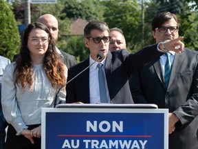 Quebec Conservative Leader Eric Duhaime, centre, stands with local candidates, to oppose to the Quebec City tramway project Sept. 7, 2022.