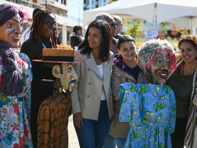 Quebec Liberal Party Leader Dominique Anglade poses for a photo with the marionettes of the Joie de Vivre Festival as she makes a campaign stop in Gatineau on Saturday, Sept. 24, 2022.