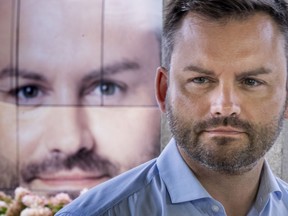 PQ Leader Paul St-Pierre Plamondon listens to a presentation from a candidate during a news conference in Montreal on Tuesday, August 30, 2022.