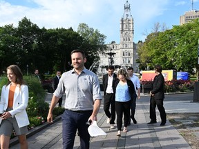 Parti Québécois Leader Paul St-Pierre Plamondon walks to a news conference outside the National Assembly in Quebec City.