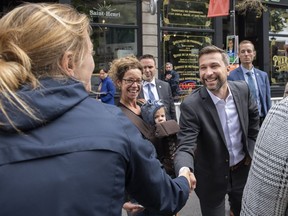 Quebec solidaire co-spokesperson Gabriel Nadeau-Dubois greets members of the public while on a walkabout during an election campaign stop in Montreal, Sunday, Sept. 4, 2022.