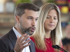 Quebec Solidaire Leader Gabriel Nadeau-Dubois speaks at a news conference while local candidate Christine Gilbert looks on, Monday, September 19, 2022 in Quebec City. Quebecers are going to the polls for a general election on Oct. 3.