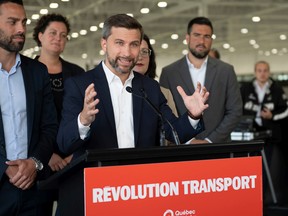 Québec solidaire co-spokesperson Gabriel Nadeau-Dubois, flanked by local candidates, speaks at a news conference on Tuesday Sept. 27, 2022 in Quebec City.