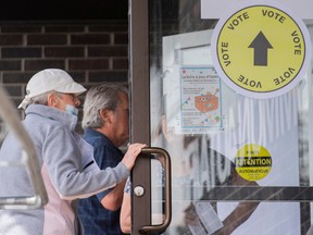 People enter an advance-polling station in L'Assomption Sept. 25, 2022.