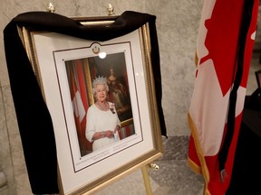 A portrait of Queen Elizabeth II and a book of condolence has been set up inside the Alberta Legislature rotunda in Edmonton, Friday, Sept. 9, 2022.
