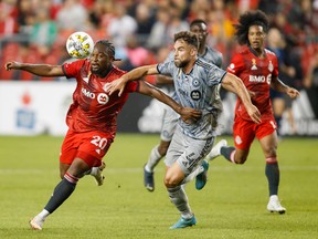 Toronto FC forward Ayo Akinola (20) and CF Montreal defender Rudy Camacho (4) battle of the ball during first half MLS soccer action in Toronto Sept. 4, 2022.