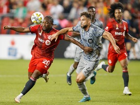 Toronto FC forward Ayo Akinola (20) and CF Montréal defender Rudy Camacho (4) battle for the ball during first half MLS soccer action in Toronto on Sunday, Sept. 4, 2022.