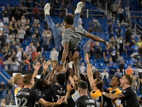 CF Montréal players throw head coach Wilfried Nancy into the air following a 2-2 draw with the Columbus Crew in front of a packed crowd at Saputo Stadium that secured an MLS playoff spot for the team on March 9. September 2022.