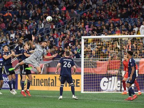 CF Montréal defender Rudy Camacho (4) makes a leaping play for the ball during the first half of a match against against the New England Revolution on Saturday, Sept. 17, 2022, at Gillette Stadium in Foxborough, Mass.