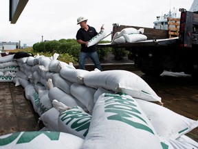Francis Bruhm, project manager for general contractor G&R Kelly, places sandbags around the doors of the Nova Scotia Power building before the arrival of Hurricane Fiona Sept. 23, 2022.