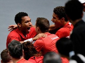 Montreal's Félix Auger Aliassime celebrates with his team after winning his Davis Cup match against Serbia's Miomir Kecmanovic on Saturday, Sept. 17, 2022, in Valencia, Spain.