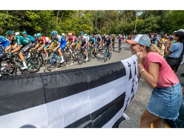 Coraline Le Jeune and her boyfriend, Sebastien Coquil, hold up the Breton flag in support of fellow Breton Warren Bargain during the Grands Prix Cyclistes in Montreal on Sunday, Sept. 11, 2022.