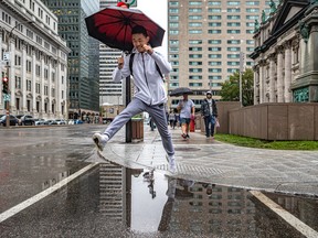 Don't let rainy days and Mondays get you down. Rise above it like Hongfei Liu in Montreal Sept. 19, 2022.