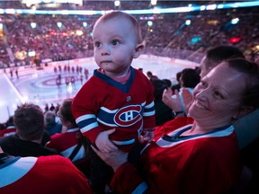 Thirteen-month old Edouard Francoeur gets into his first Montreal Canadiens game with mother Bianca Jette and father Martin Francoeur prior to first period NHL action against the Toronto Maple Leafs in Montreal on Wednesday October 12, 2022.