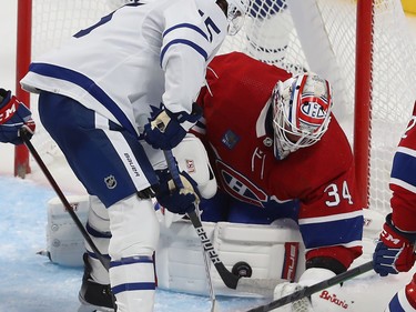 Canadiens goaltender Jake Allen stops the puck in front of Toronto Maple Leafs' Alexander Kerfoot (15) during third period NHL action in Montreal on Wednesday Oct. 12, 2022.