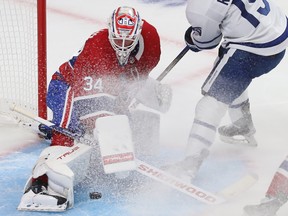 Canadiens goaltender Jake Allen stops the puck on Toronto Maple Leafs' Alexander Kerfoot (15) during second period NHL action in Montreal on Wednesday Oct. 12, 2022.