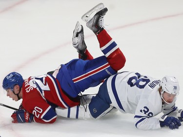 Canadiens' Juraj Slafkovsky (20) is tripped by Toronto Maple Leafs' Rasmus Sandin (38) during first period NHL action in Montreal on Wednesday October 12, 2022. Sandin received a penalty on the play.