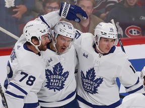 Maple Leafs' Michael Bunting (58) celebrates his goal with teammates TJ Brodie (78) and Mitchell Marner (16) during first period NHL action against the Montreal Canadiens in Montreal on Wednesday Oct. 12, 2022.
