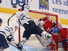 Toronto Maple Leafs' Nicolas Aube-Kubel (96) flies into the goal crease of Montreal Canadiens goaltender Jake Allen during third period NHL action in Montreal on Wednesday Oct. 12, 2022.
