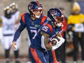 Montreal Alouettes quarterback Trevor Harris hands the ball to rushewr Walter Fletcher during second half against Hamilton Tiger-Cats in Montreal on Spet. 23, 2022.