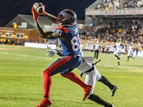 Montreal Alouettes' Eugene Lewis catches the game-winning pass from quarterback Trevor Harris over Hamilton Tiger-Cats defensive-back Richard Leonard during second half in Montreal on Sept. 23, 2022.