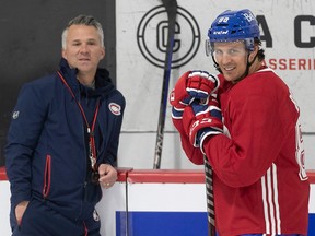 Montreal Canadiens head coach Martin St-Louis talks with Gabriel Bourque during the first day of training camp in Brossard on Sept. 22, 2022.