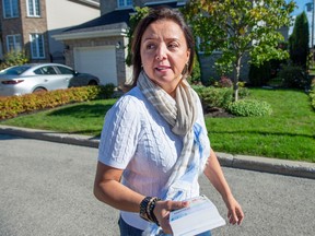 CAQ candidate Alice Abou-Khalil is shown canvassing in Fabre riding, where she held a 300-vote lead over her Liberal rival late Monday.