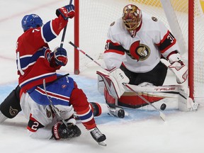 Montreal Canadiens' Jake Evans (71) falls back onto Ottawa Senators' Artem Zub (2), on play in front of Ottawa Senators goaltender Anton Forsberg during second period pre-season NHL action in Montreal on Tuesday Oct. 4, 2022.