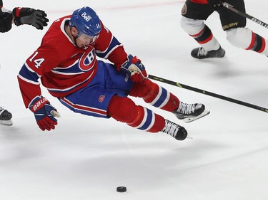 Montreal Canadiens' Nick Suzuki (14) falls to the ice during second period pre-season NHL action in Montreal on Tuesday Oct. 4, 2022.