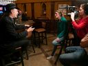 Director Elise Bronsart, in green, interviews historian Pierre Anctil at Winnie's pub, one of Mordecai Richler’s most frequented watering-holes, on Crescent St.