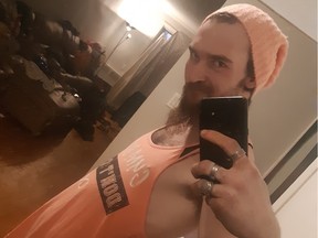 Rance Sullivan, wearing a tank top in a residence, takes a mirror selfie