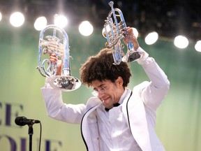 Rafael Payare carries Pacho Flores’s trumpets offstage at the OSM’s Olympic Park concert on Wednesday, August 10, 2022.