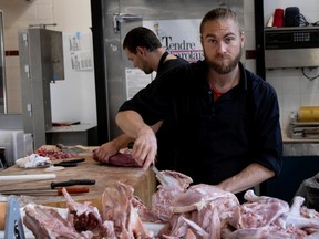 Jimmy Bodic, a butcher at Ferme Saint-Vincent, sections turkey at the Atwater Market on Friday.