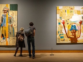 Visitors read descriptions at the Seeing Loud: Basquiat and Music exhibition at the Montreal Museum of Fine Arts in October.