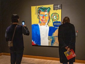 MONTREAL, QUE.: \October\ 11, 2022 -- A visitor takes a photograph at the Seeing Loud: Basquiat and Music exhibition at the Montreal Museum of Fine Arts in Montreal Tuesday October 11, 2022.