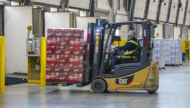 Forklifter operator drives a pallet of beer to the loading dock at the Molson Coors brewery in Longueuil.