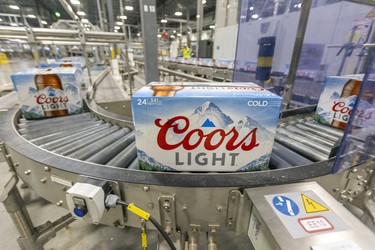 Cases of Coors light roll along the production line at the Molson Coors brewery in Longueuil.