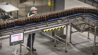 A worker checks on the bottling line at the Molson Coors brewery in Longueuil.