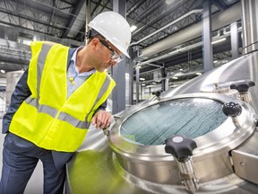 Molson Coors Canada president Frederic Landtmeters looks into a mash tun at the company's new plant in Longueuil, across the street from St-Hubert Airport.