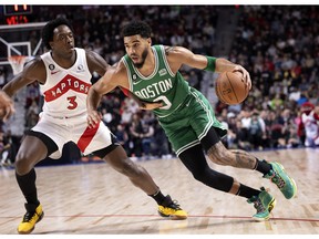 Toronto Raptors forward OG Anunoby (3) tries to slow down Boston Celtics forward Jayson Tatum (0) during a preseason NBA game, in Montreal on Friday, Oct. 14, 2022.