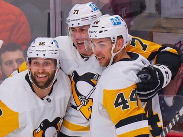 Pittsburgh Penguins Evgeni Malkin, centre, celebrates his second goal of the game with team-mates Jason Zucker, left, and Jan Rutta during the second period at the Bell Centre in Montreal Monday Oct. 17, 2022.