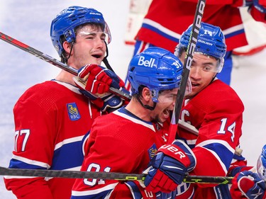 Canadiens Kirby Dach, left, celebrates his game-winning goal with teammates Sean Monahan and Nick Suzuki, right, during overtime against the Pittsburgh Penguins in Montreal Monday Oct. 17, 2022.