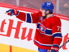 Canadiens' Kirby Dach points at team-mates after scoring the game-winning goal against the Pittsburgh Penguins during overtime at the Bell Centre in Montreal Monday Oct. 17, 2022.