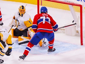 Canadiens' Kirby Dach shoots the puck past Pittsburgh Penguins' Casey DeSmith for the game-winning goal during overtime at the Bell Centre in Montreal Monday Oct. 17, 2022.