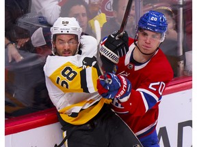 Montreal Canadiens forward Juraj Slafkovsky rides Pittsburgh Penguins' Kris Letang into the boards during third period in Montreal on Oct. 17, 2022.