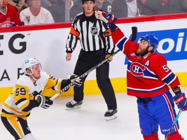 Canadiens' David Savard knocks down a loose puck in front of Pittsburgh Penguins' Jake Guentzel during the first period at the Bell Centre in Montreal Monday Oct. 17, 2022.