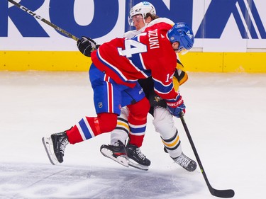 Canadiens' Nick Suzuki collides with Pittsburgh Penguin Rickard Rakell during the first period at the Bell Centre in Montreal Monday Oct. 17, 2022.